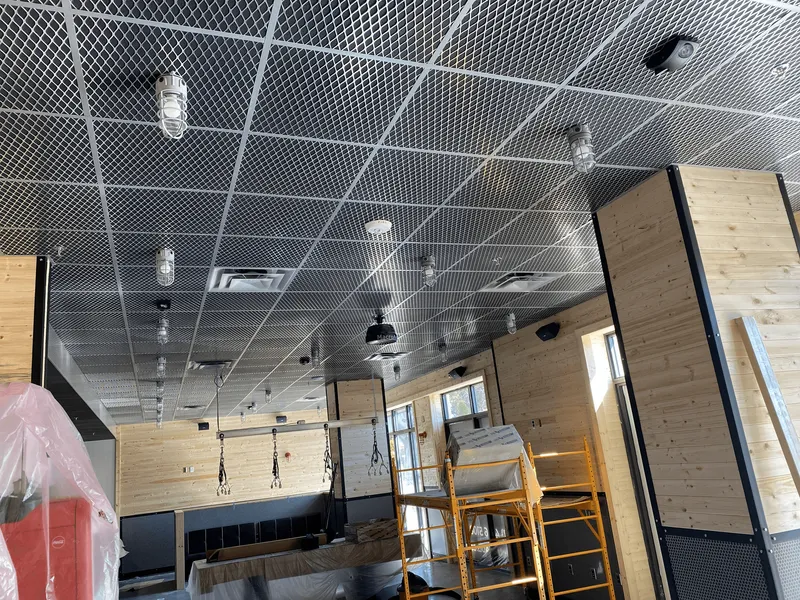 Exposed suspended ceiling grid during a commercial interior project